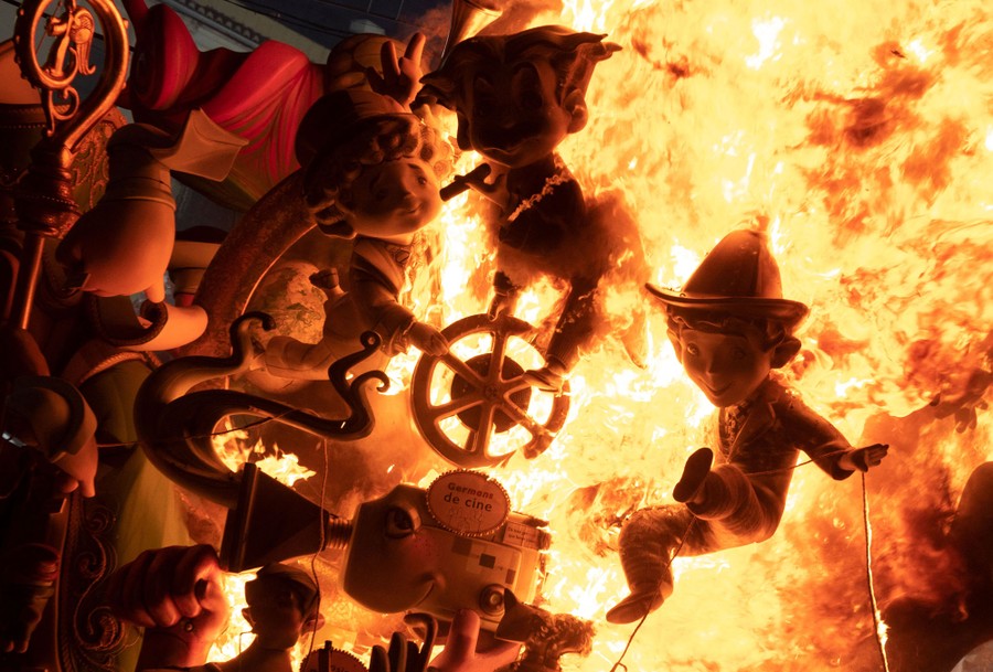 Small figurines burn during a festival.