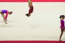 photo of several gymnasts warming up