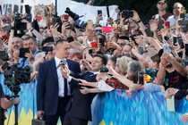 Ukrainian President Volodymyr Zelensky poses for selfies with voters.