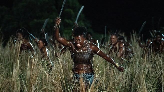 Viola Davis and other woman charging through a field as warriors in "The Woman King"