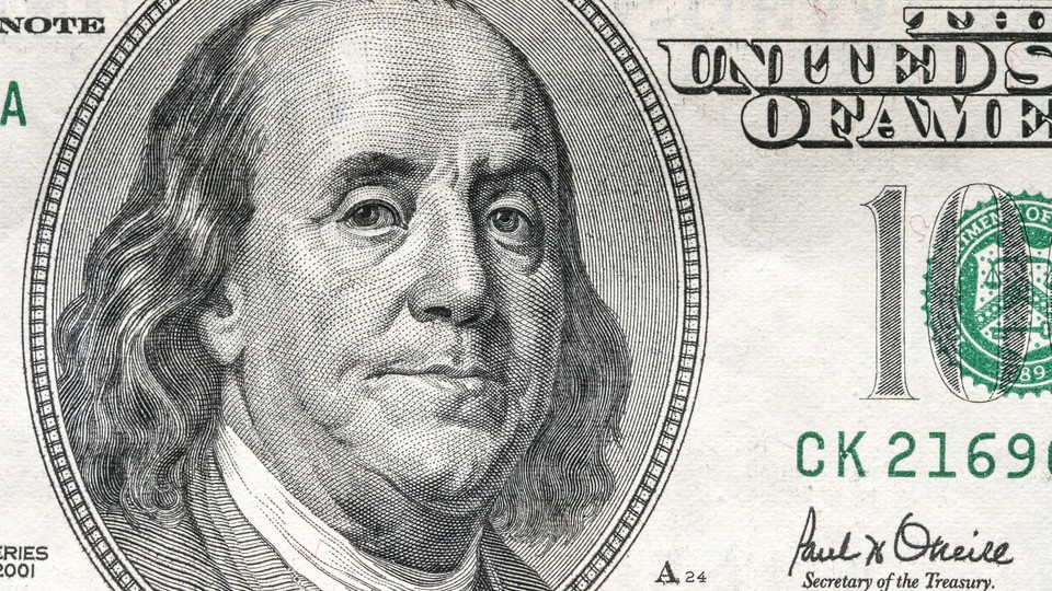 A close-up of Benjamin Franklin on the $100 bill