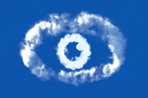 Cloudlike white forms in the shape of an eye against a sky-blue background