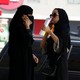 Saudi women speak on their phones in Riyadh.