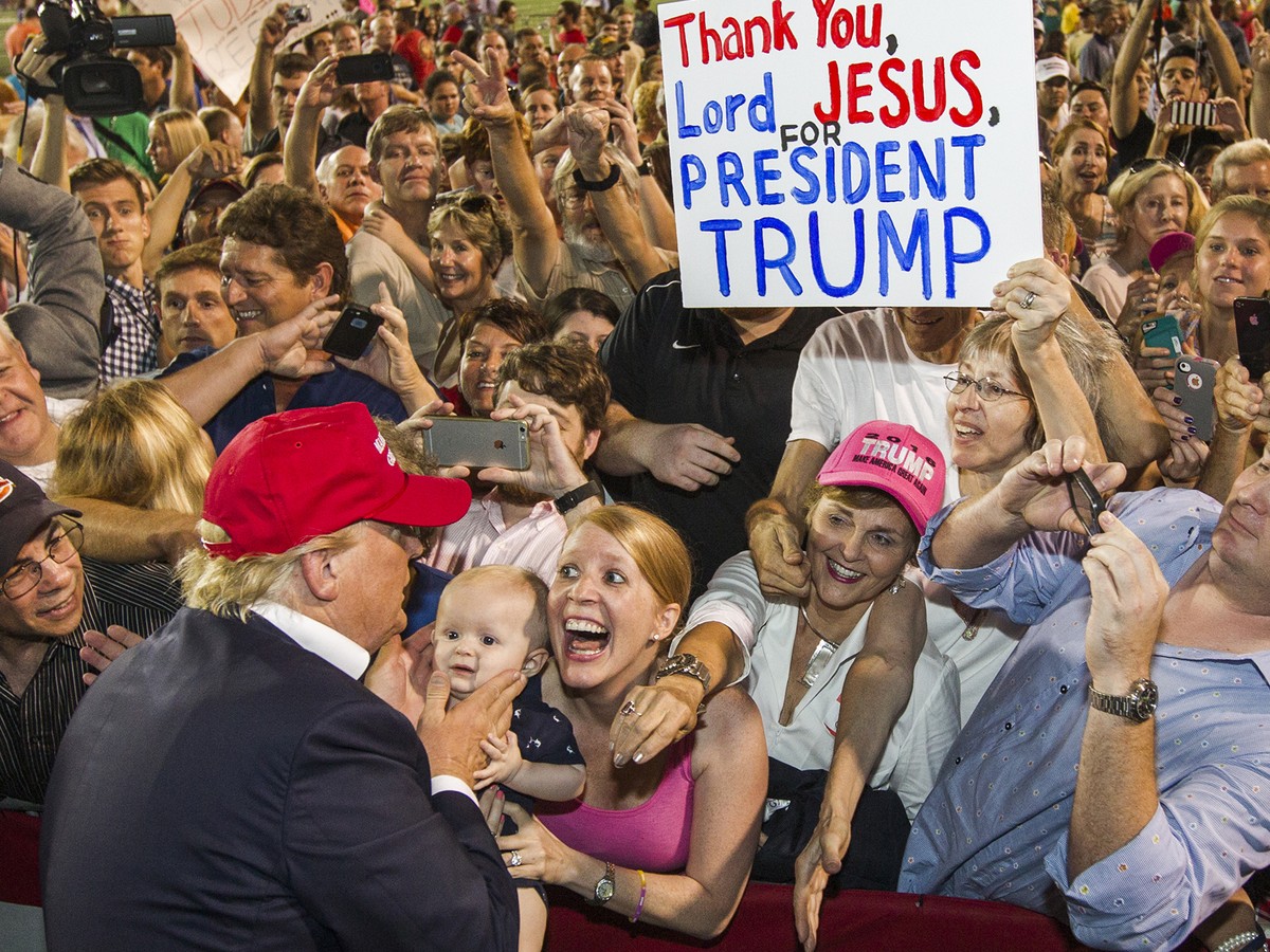 Donald Trump meets a crowd of star-crossed Evangelicals, one of whom is holding up a big sign that reads, "THANK YOU, LORD JESUS, FOR PRESIDENT TRUMP!"