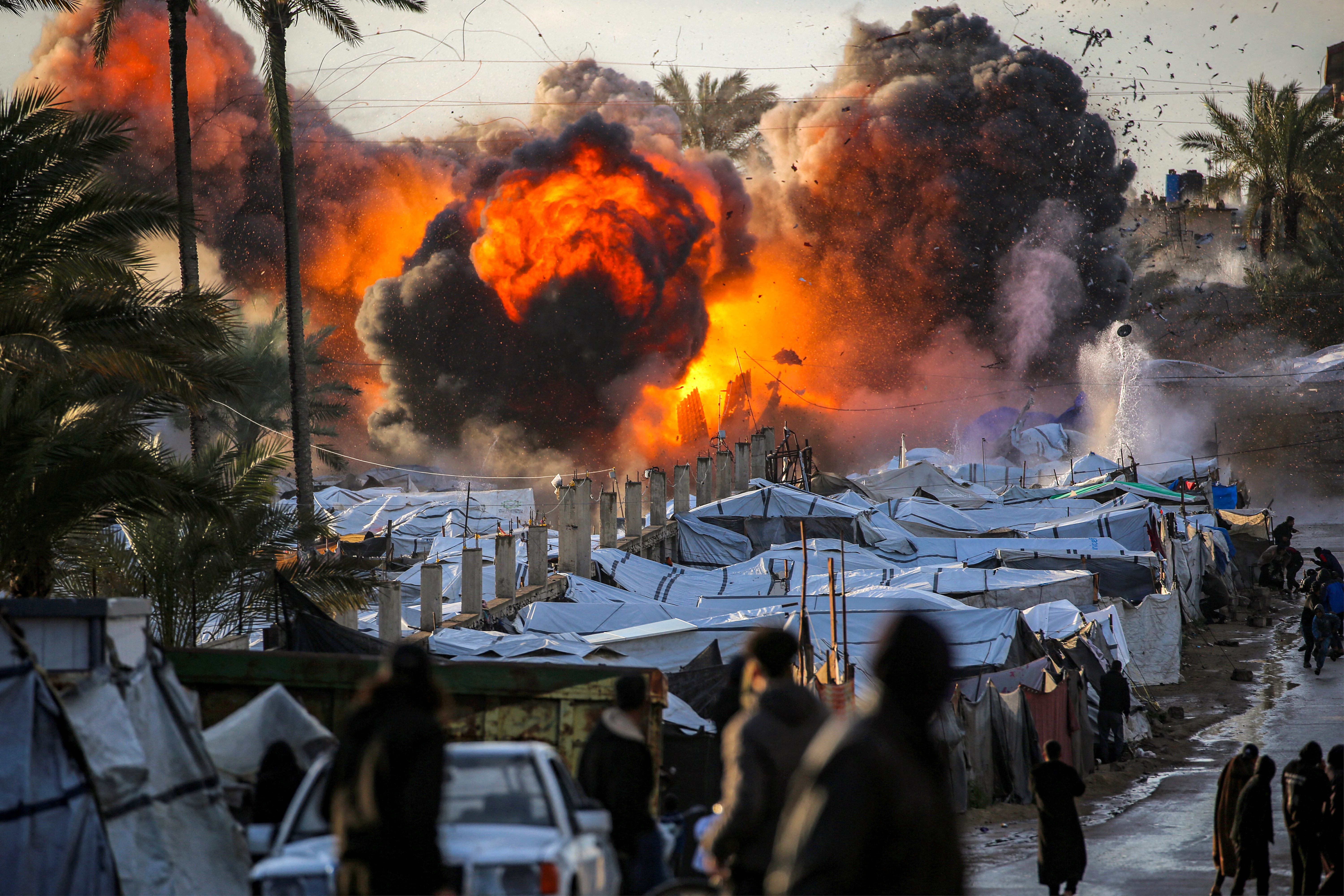 A fireball erupts following an Israeli strike near a tent encampment.