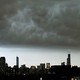 The Chicago skyline under a dark cloud