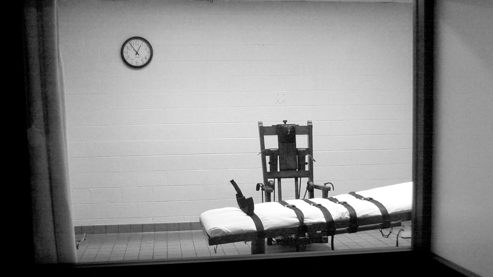 A black-and-white photo of a gurney in an execution room