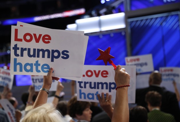 A supporter holds a sign saying "Love trumps hate" at the 2016 Democratic national convention.