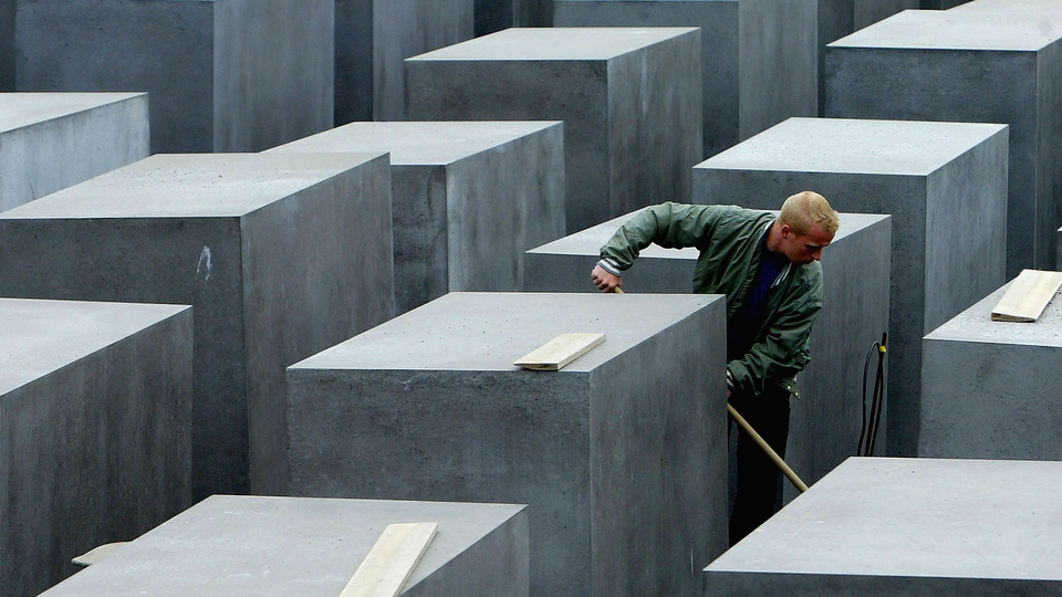 A worker at the Memorial to the Murdered Jews of Europe cleans the memorial grounds.