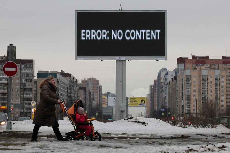 A woman pushes a baby in a stroller past a digital advertising screen that reads "Error: No Content."