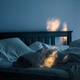 an empty bed with the covers mussed