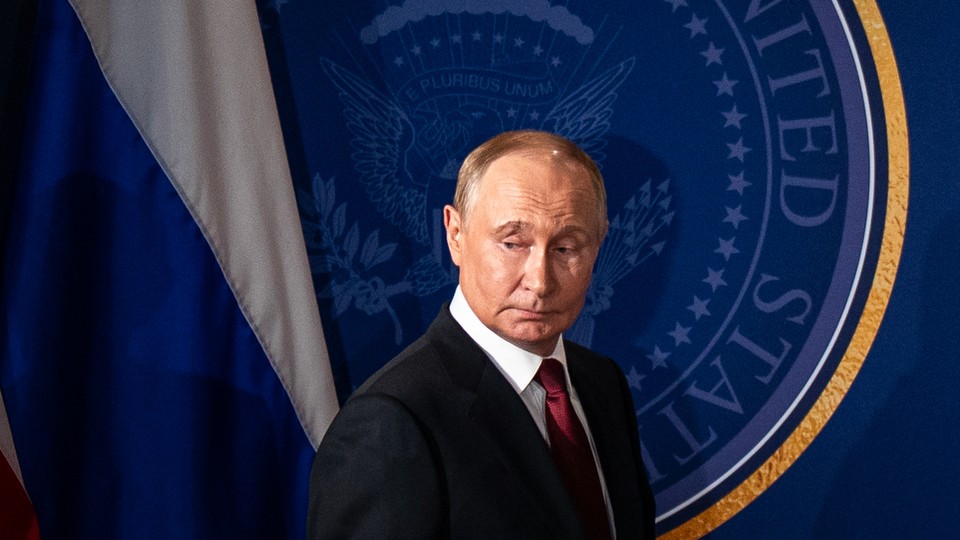 Photograph of Vladimir Putin in front of the seal of the United States