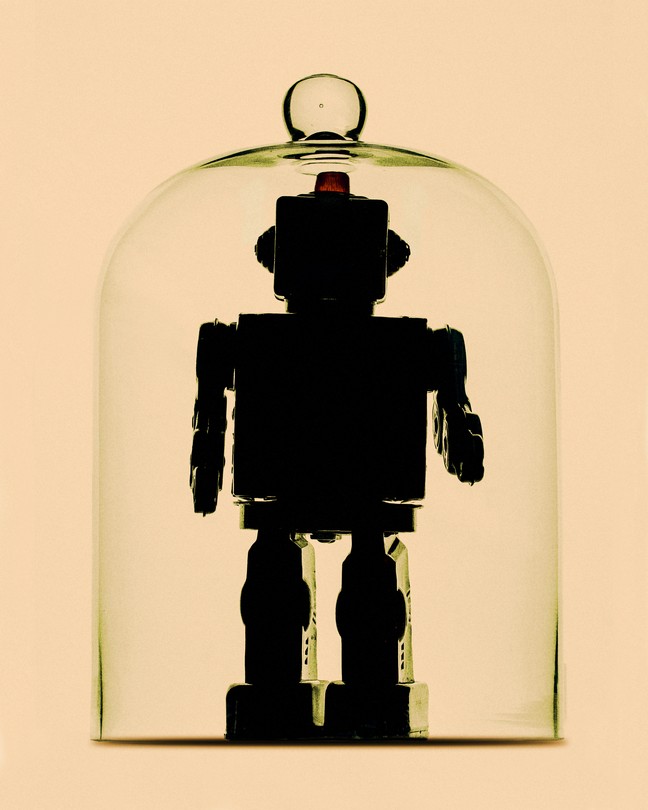 A humanoid robot inside a bell jar