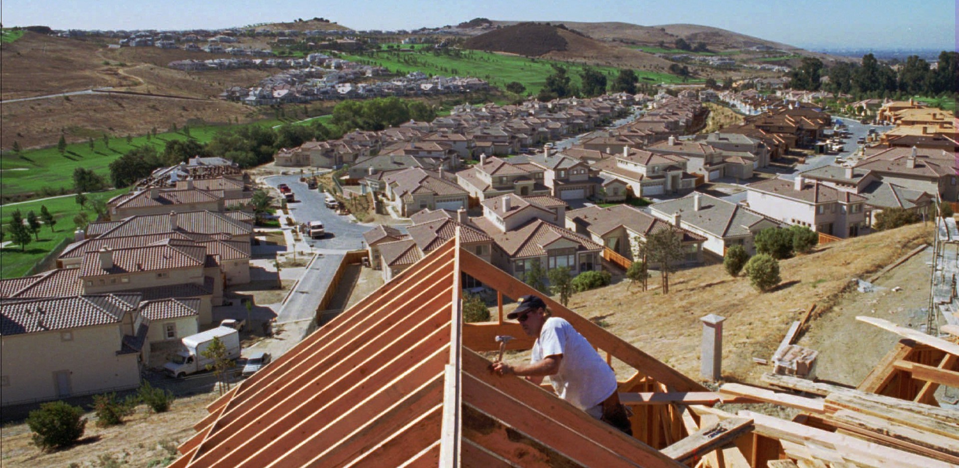 A worker builds new homes in San Jose.