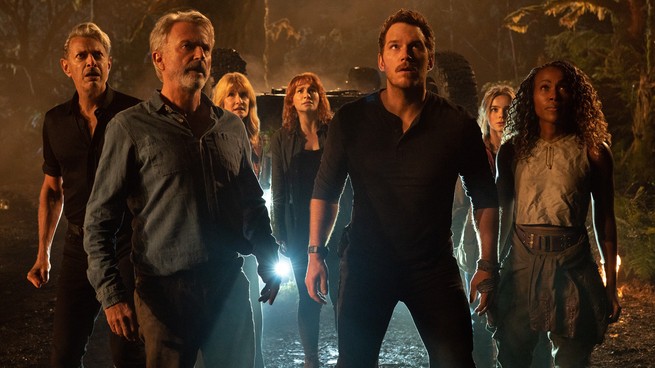 A group staring up in awe at a dinosaur in "Jurassic World: Dominion"