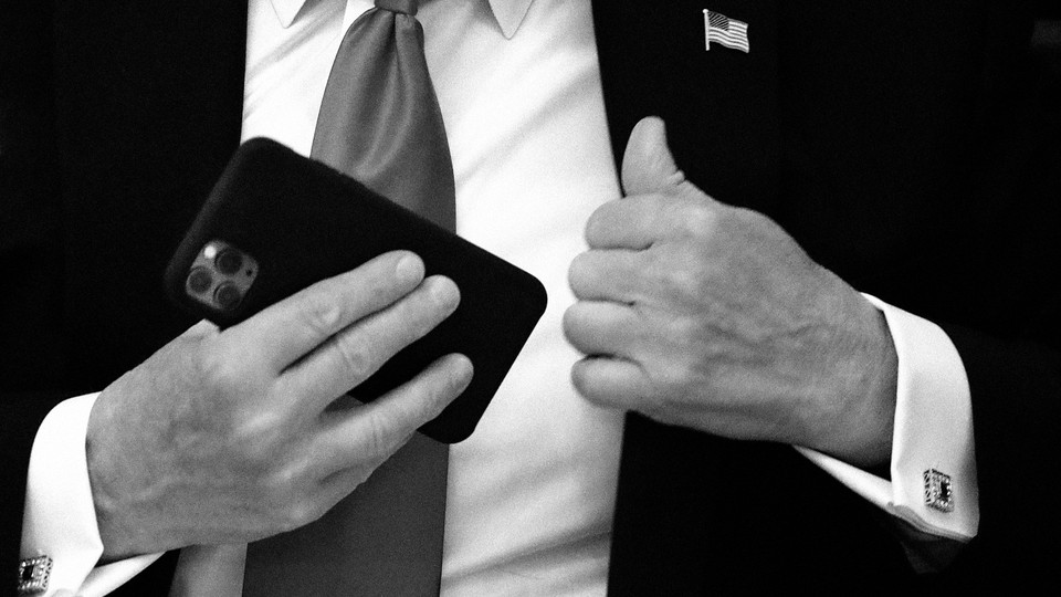 A man putting a phone in his jacket pocket