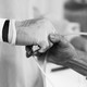 A doctor holds a patient's hand in the Covid-19 alternative care site, built into a parking garage, at Renown Regional Medical Center, December 16, 2020 in Reno, Nevada.