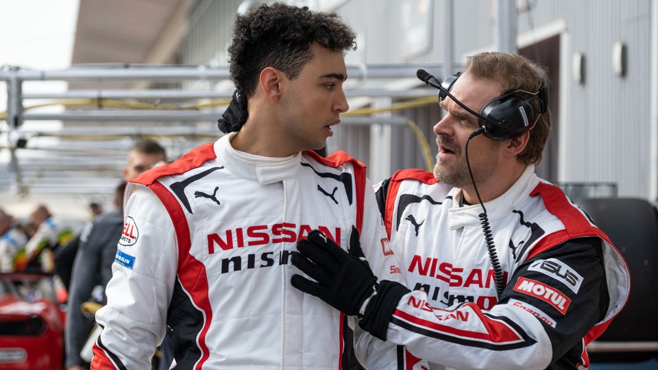 Two men on a race course in conversation, in "Gran Turismo"