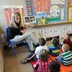 A teacher reads to sitting schoolchildren