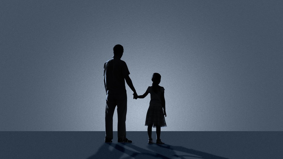 Sillhouettes of a father and daughter holding hands
