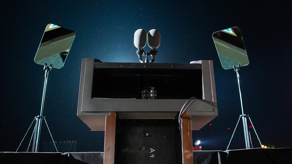 Photograph of an empty podium and teleprompter