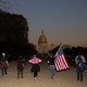 People celebrating the election of Joe Biden as president walk toward the U.S. Capitol building.