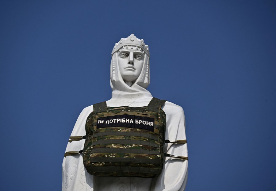 A statue of a historical princess with a modern bulletproof vest wrapped around it