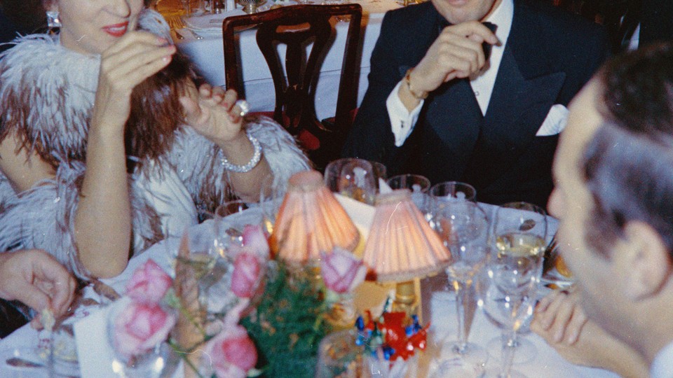 A photo of people gathered around a dinner table