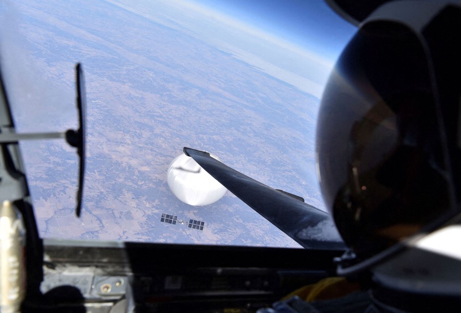 A view out the window of a U-2 spy plane, looking down at a large white balloon