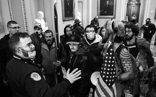 A police officer talking to insurrectionists