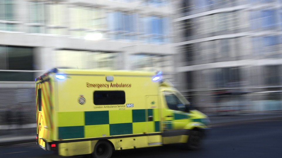 An ambulance speeds down a city street.