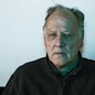 Photograph of Werner Herzog staring intently at the camera