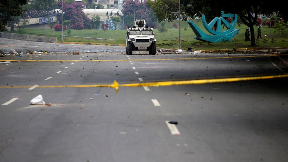 An armored vehicle drives along an empty street during an opposition strike in Caracas on July 20, 2017.