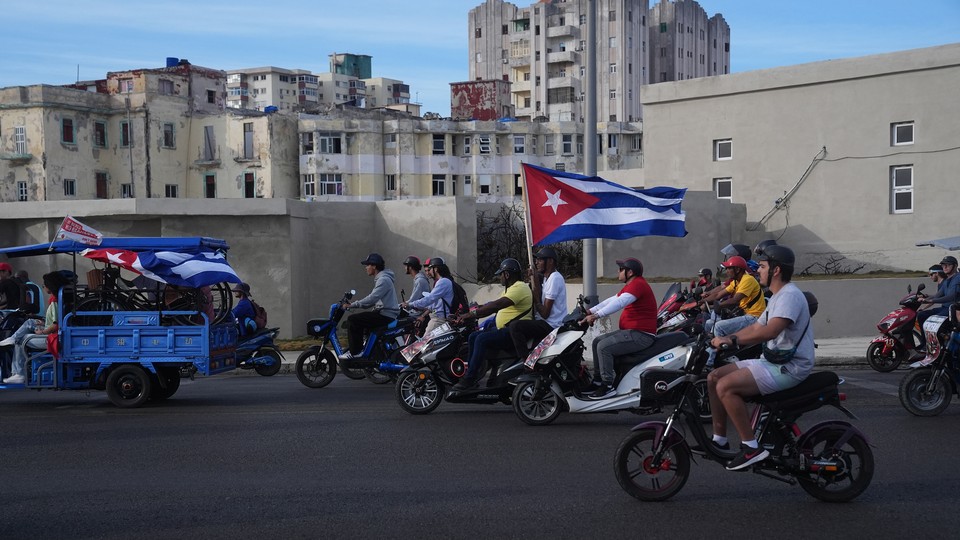Motorcycles in Cuba holding the flag