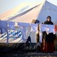 A woman hangs laundry at a refugee camp in Syria in March 2017.