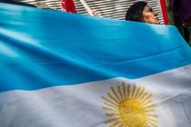 Photograph of a woman holding an Argentinian flag