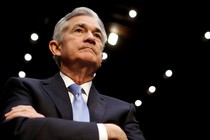 Jerome Powell looking up with arms crossed