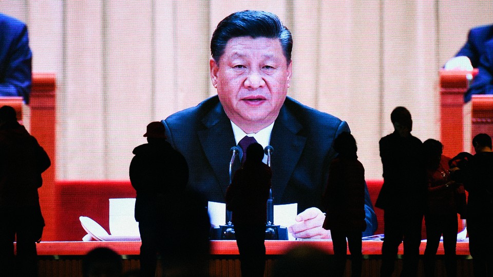 A large screen showing Xi Jinping