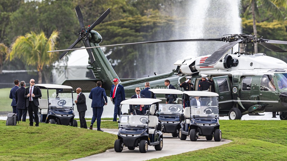 Donald Trump exits a military helicopter at his own golf resort