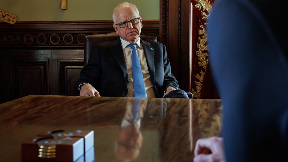 A color photograph of Tim Walz seated in his office