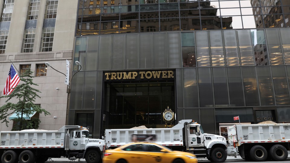 Dump trucks form a protective cordon around Trump Tower during an August visit by the president.