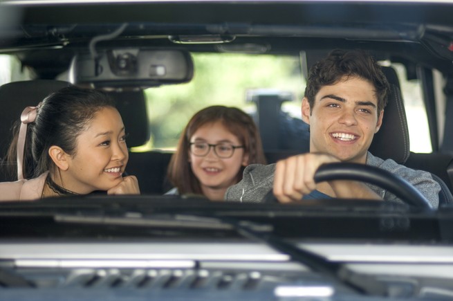 Lana Condor, Anna Cathcart, and Noah Centineo smiling and sitting in a car in "To All the Boys I’ve Loved Before"