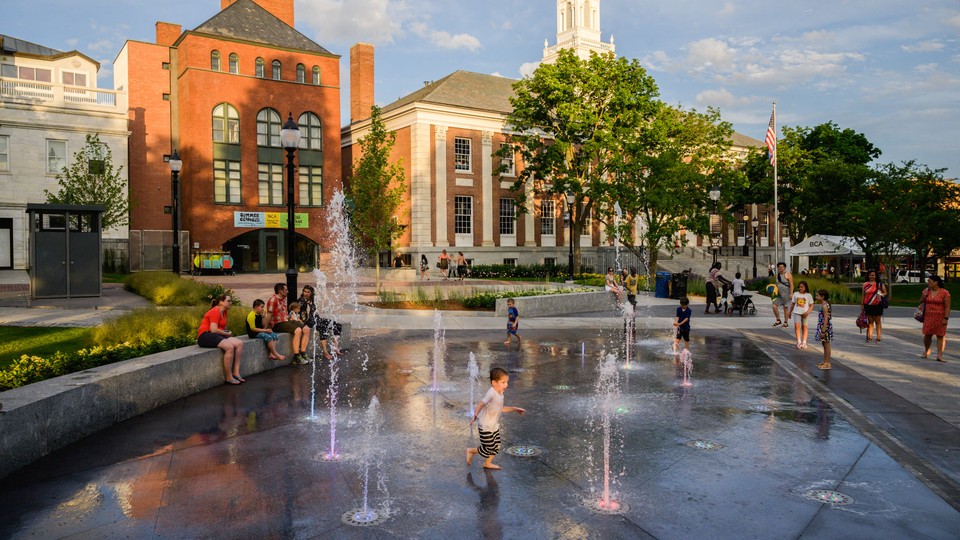 Children splash in a fountain in Burlington, Vermont.