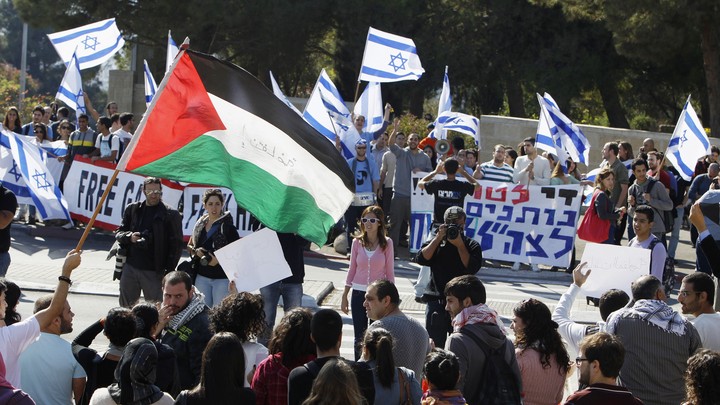 Protesters hold pro-Israel and pro-Palestine posters during a demonstration in Jerusalem.