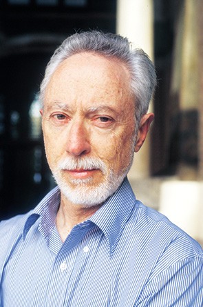 photo of man with white hair and beard in blue-striped oxford button-down.