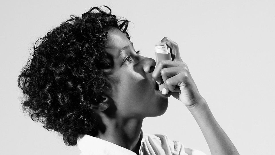 Photo of a person using an inhaler