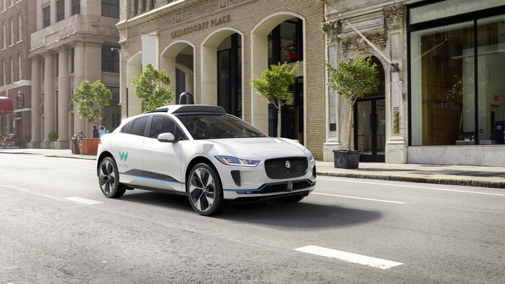A white self-driving car on a road