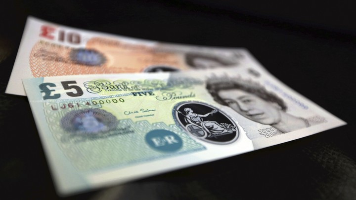 Sample plastic five and 10 pound notes on display at the Bank of England in London.