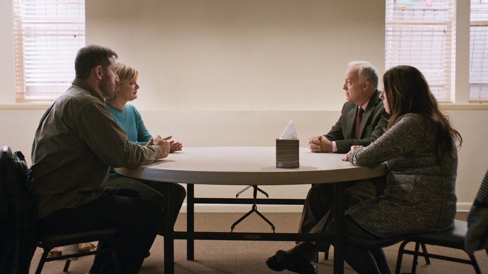 The four parents in "Mass" sit at a table.