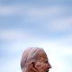 A photograph of Joe Biden's head in profile against a hazy blue sky